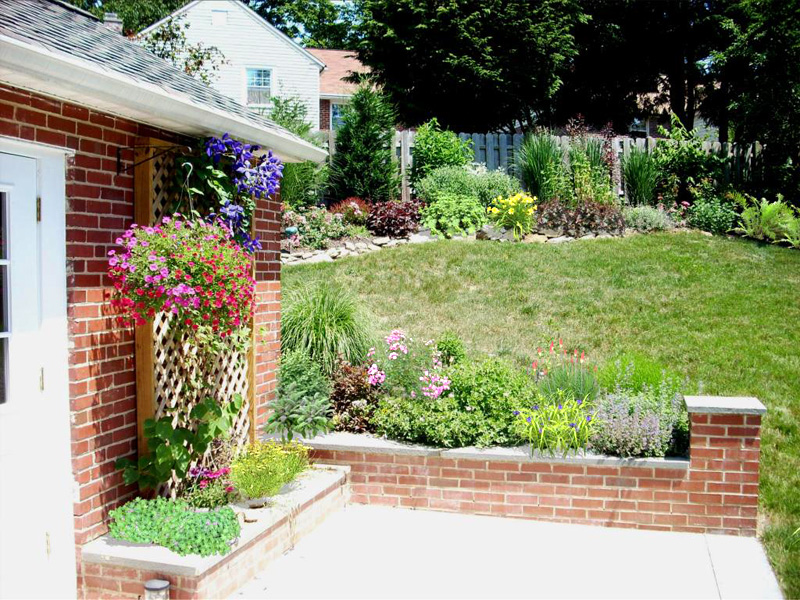 Backyard Designs - Garden With Wall and Perennials in Devon - After