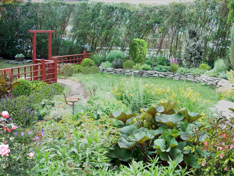 Backyard Landscaping Ideas - Japanese-Influenced Fence With Stone Walls and Perennials in Frazer - After